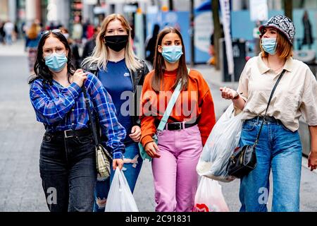 Antwerp, Belgium. 27th July, 2020. Shoppers wearing face masks as a preventive measure walk on the street during the coronavirus crisis.The wearing of a face mask will become compulsory from Saturday in shops and some other indoor spaces where people gather. Credit: SOPA Images Limited/Alamy Live News Stock Photo