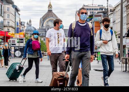 Antwerp, Belgium. 27th July, 2020. People wearing face masks as a preventive measure walk on the street during the coronavirus crisis.The wearing of a face mask will become compulsory from Saturday in shops and some other indoor spaces where people gather. Credit: SOPA Images Limited/Alamy Live News Stock Photo