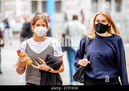 Antwerp, Belgium. 27th July, 2020. People wearing face masks as a preventive measure walk on the street during the coronavirus crisis.The wearing of a face mask will become compulsory from Saturday in shops and some other indoor spaces where people gather. Credit: SOPA Images Limited/Alamy Live News Stock Photo