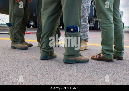 A close up of officers storing their caps in their pant legs. The crew is from a C-5 Air Force plane flown by the Air National Guard from West Virgini Stock Photo