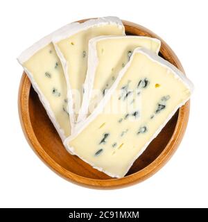 Slices of soft cheese with white and blue mold in wooden bowl. Creamy cheese, surface ripened with white fungus and inside with a blue one. Stock Photo