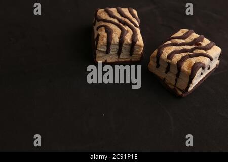 Closeup of the delicious biscuits with chocolate isolated on a black background Stock Photo