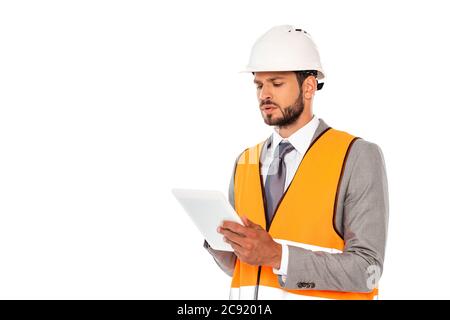 Handsome engineer in suit and safety vest using digital tablet isolated on white Stock Photo