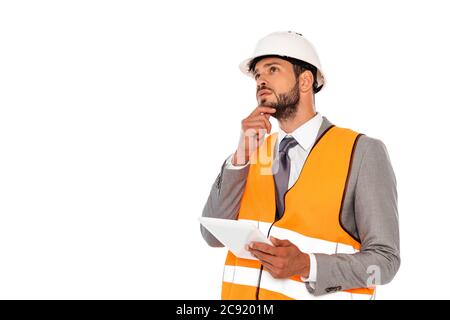Pensive engineer in suit and hardhat holding digital tablet isolated on white Stock Photo