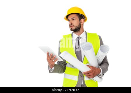 Handsome engineer holding blueprints and digital tablet while looking away isolated on white Stock Photo