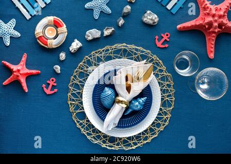 Contemporary summertime table setting with nautical sea
