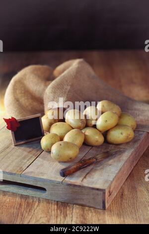 potatoes on black background, potatoes on a wooden table Stock Photo