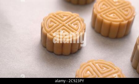 Homemade cantonese moon cake pastry on baking tray before baking for traditional festival, close up, lifestyle. Stock Photo