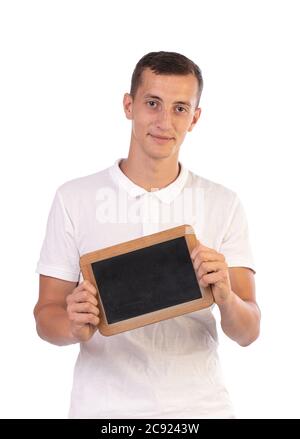 Young man holding a blackboard to write on it on a white background Stock Photo