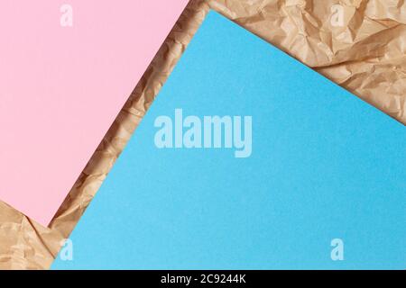 Abstract geometric paper texture background. Blank light blue and pink paper sheet over recycle crumpled brown paper background Stock Photo