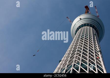 Cranes at the Tokyo Skytree construction site in Japan.Tokyo Sky Tree under construction. In this image this new telecommunication tower stands at 398 metres and when finished will measure 634 metres from top to bottom making it the tallest structure in East Asia. Oshiage, Tokyo, Japan. Stock Photo