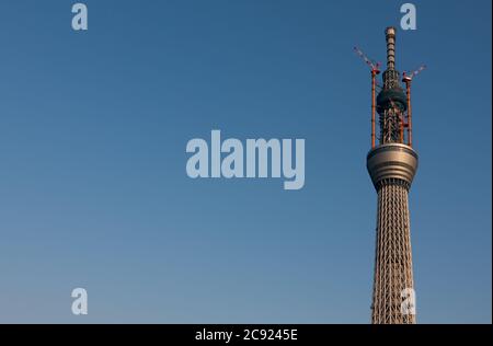 Cranes at the Tokyo Skytree construction site in Japan.Tokyo Sky Tree under construction. In this image this new telecommunication tower stands at 398 metres and when finished will measure 634 metres from top to bottom making it the tallest structure in East Asia. Oshiage, Tokyo, Japan. Stock Photo