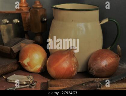 Still life - grandmother's kitchen with old mug and onion arranged on a table Stock Photo
