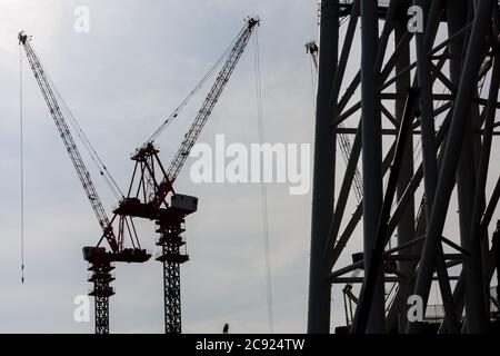 Tokyo, Japan. 21st June, 2010. Cranes at the Tokyo Skytree construction site in Japan.Tokyo Sky Tree under construction. In this image this new telecommunication tower stands at 398 metres and when finished will measure 634 metres from top to bottom making it the tallest structure in East Asia. Oshiage, Tokyo, Japan. Credit: Damon Coulter/SOPA Images/ZUMA Wire/Alamy Live News Stock Photo