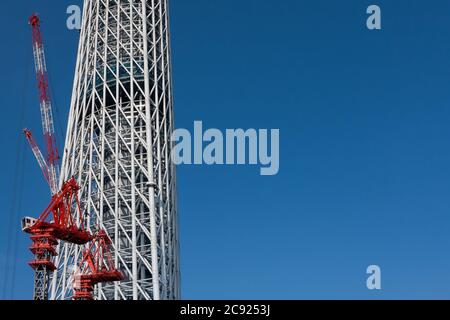 Tokyo, Japan. 21st June, 2010. Cranes at the Tokyo Skytree construction site in Japan.Tokyo Sky Tree under construction. In this image this new telecommunication tower stands at 398 metres and when finished will measure 634 metres from top to bottom making it the tallest structure in East Asia. Oshiage, Tokyo, Japan. Credit: Damon Coulter/SOPA Images/ZUMA Wire/Alamy Live News Stock Photo