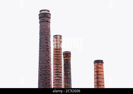 Four tall pipes of red brick, factory chimney Stock Photo