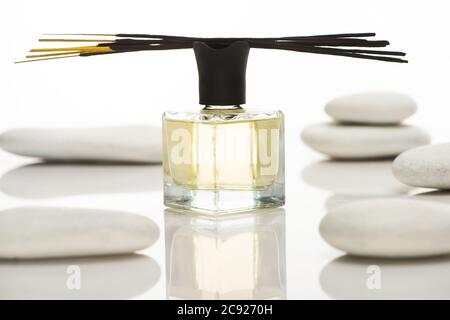 selective focus of aroma sticks and perfume near spa stones isolated on white Stock Photo