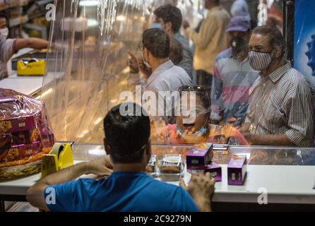 Srinagar, Indian-controlled Kashmir. 28th July, 2020. People shop at a bakery ahead of the Eid Al-Adha festival in Srinagar, the summer capital of Indian-controlled Kashmir, July 28, 2020. Credit: Javed Dar/Xinhua/Alamy Live News Stock Photo