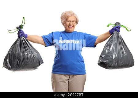 Mature lady volunteer posing with two waste bags isolated on white background Stock Photo
