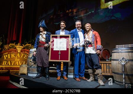 Rust, Germany. 28th July, 2020. Thomas Mack (2nd from left), managing partner of Europa-Park and Michael Mack (2nd from right), managing partner of Europa-Park, stand on the podium in a cinema on the Europa-Park grounds together with two pirate actors during a press conference for the reopening of the ride attraction 'Pirates in Batavia'. The attraction had been destroyed by a huge fire in May 2018. Fans had called for the reconstruction of the ride, among other things, with signature campaigns. Credit: Philipp von Ditfurth/dpa/Alamy Live News Stock Photo
