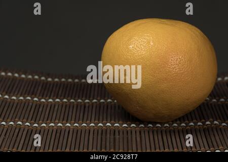One grapefruit on a bamboo background Stock Photo