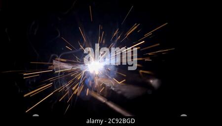 welder working with electrode at semi-automatic arc welding in manufacture production plant Stock Photo