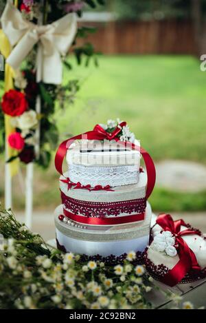 decoration of wedding table. flowers in vase with gift boxes that stand on each other and ball Stock Photo