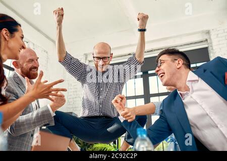 Excited diverse business team employees screaming celebrating good news business win corporate success, happy multi-ethnic colleagues workers group Stock Photo