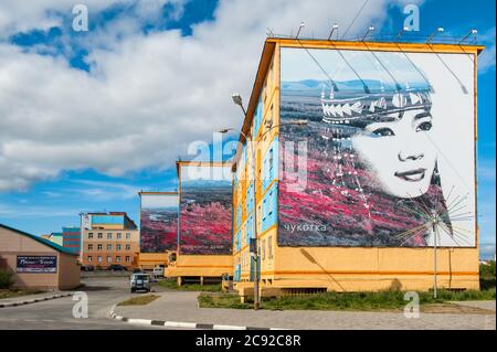 Coloured apartment houses with mural of native Chukchi people, Siberian city Anadyr, Chukotka Province, Russian Far East Stock Photo