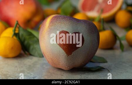 Red apple with a heart symbol. concept of love and health. healthy lifestyle and proper nutrition. Stock Photo