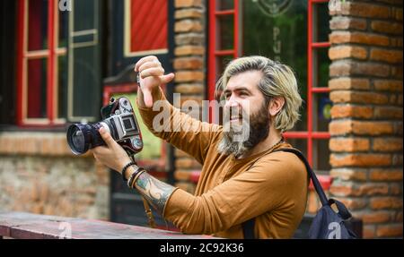 professional look. capture these memories. SLR camera. hipster man with beard use professional camera. photographer hold retro camera. journalist is my career. reporter make photo. vintage camera. Stock Photo