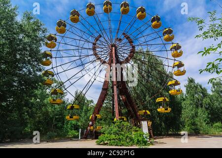 Abandoned Amusement Car Ride in park of attractions in Ghost City of Pripyat in Chernobyl Exclusion Zone, nuclear catastrophe Stock Photo