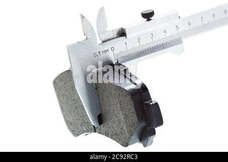 brake pads, measurement by a caliper of thickness car spare part, isolated nobody. Stock Photo