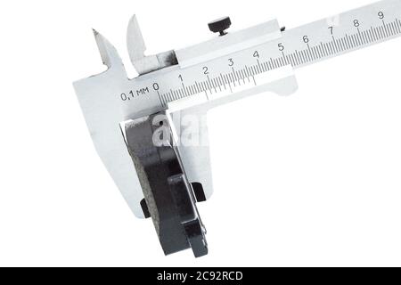 brake pads, measurement by a caliper of thickness car spare part, isolated nobody. Stock Photo