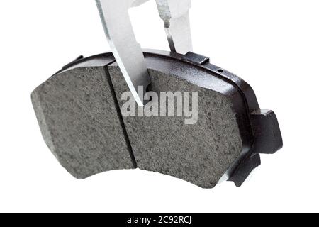 brake pads, measurement by a caliper of thickness car spare part, isolated nobody. Stock Photo