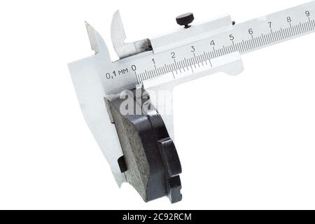 brake pads, measurement by a caliper of thickness car spare part, isolated nobody. Stock Photo