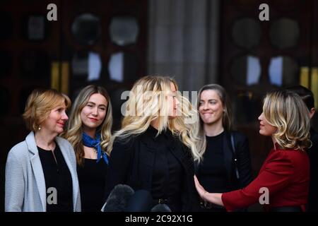 Actress Amber Heard, alongside her sister Whitney Henriquez (second right) and lawyer Jen Robinson (right), as she gives a statement outside the High Court in London on the final day of hearings in Johnny Depp's libel case against the publishers of The Sun and its executive editor, Dan Wootton. After almost three weeks, the biggest English libel trial of the 21st century is drawing to a close, as Mr Depp's lawyers are making closing submissions to Mr Justice Nicol. . Stock Photo