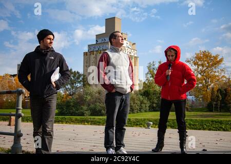 MONTREAL, CANADA - Oct 16, 2010: Montreal, Quebec / Canada - October 16 2010: Reporter Wearing a Red Clothes is Holding a Microphone in her Hand for R Stock Photo