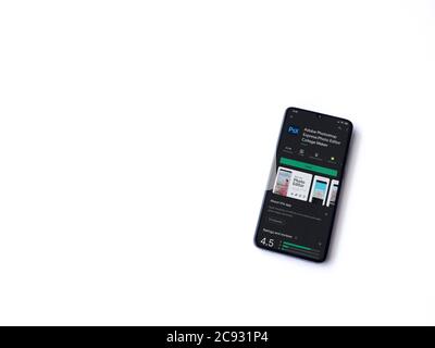 Lod, Israel - July 8, 2020: Adobe Photoshop Express Photo Editor app play store page on the display of a black mobile smartphone isolated on white bac Stock Photo