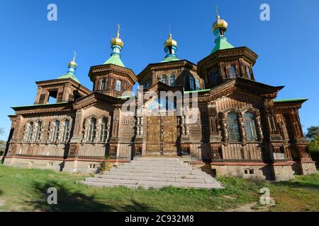 Holy Trinity Orthodox Cathedral in Karakol, Kyrgyzstan in Issyk-Kul Region. Wooden building with facade decorated with carvings. Russian orthodox. Stock Photo