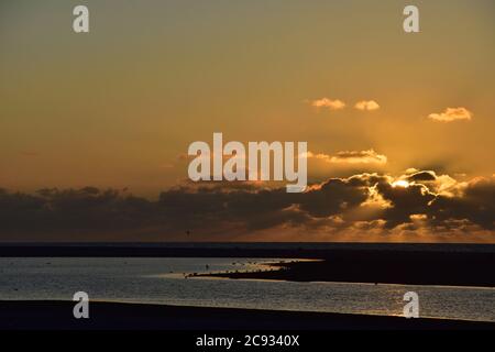 Fairy-tale sunset and clouds in the sky over the sea. Summer. Stock Photo