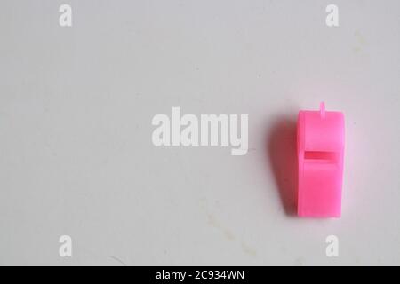 Pink plastic whistle toy isolated on a white background Stock Photo