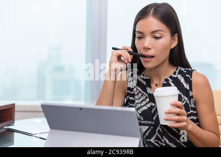 Asian business woman busy working on office laptop Stock Photo