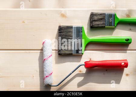 Set of tools for painting on wooden backgrond.painting wall by the roller brush for protection and corrosion.Painting apartment, renovating with color Stock Photo
