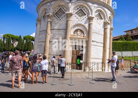 Pisa, Italy - August 14, 2019: Large group of tourists in front of the Leaning Tower of Pisa, region of Tuscany, Italy