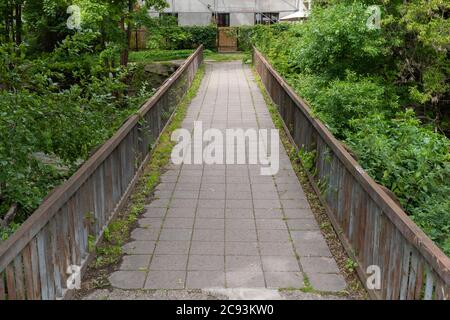 Crossing the Vilnia river into Uzupis an alternative neighbourhood in the old town of Vilnius, Lithuania. Stock Photo