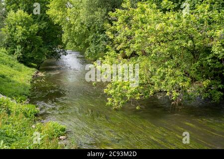 The river Vilinia along the Uzupis district an alternative neighbourhood in the old town of Vilnius, Lithuania. Stock Photo