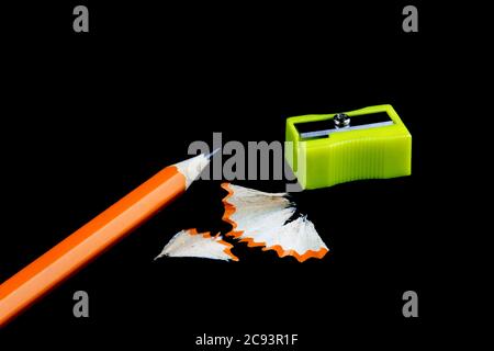 Pencil,pencil sharpener and pencil shavings isolated against a black background Stock Photo