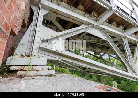 Old riveted steel bridge over the river. River crossing for the railroad. Summer season. Stock Photo