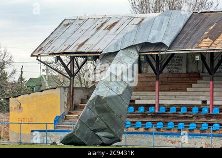 Zrenjanin, Serbia, March 01, 2020. Damaged and torn sheet metal from the roof of the football stadium in the city. The damage was caused by stormy win Stock Photo